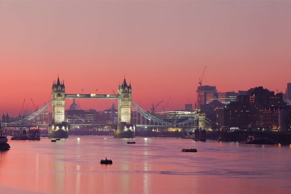 Pink sunset on the river and the city