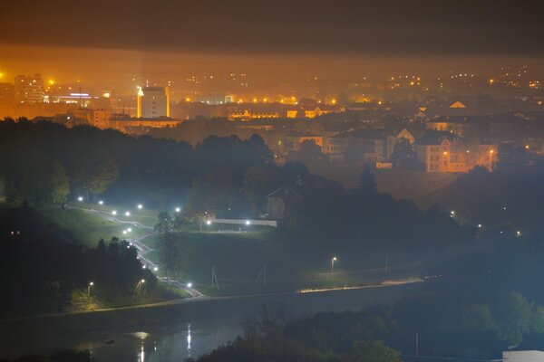 A night city surrounded by fog