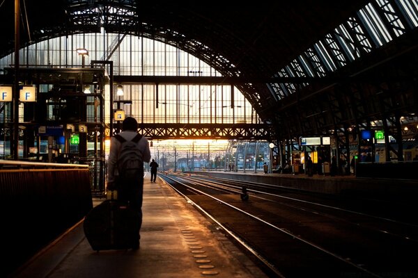 A man with a suitcase at the railway station