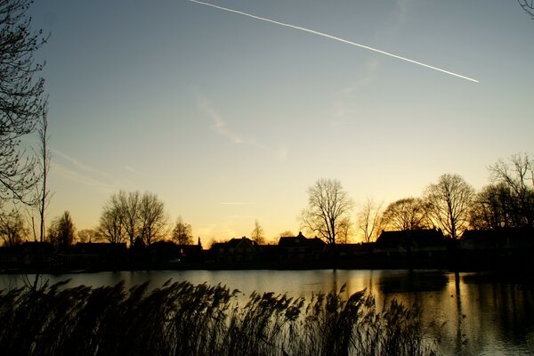 The trail of a flying plane Under the forest