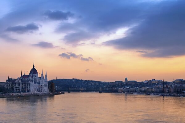 Architectural buildings at sunset with a lake