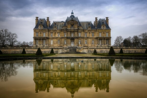 The European castle is reflected in the water