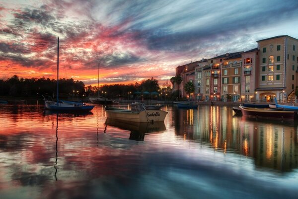 A riot of colors crimson black sky in a mirror image in the pond