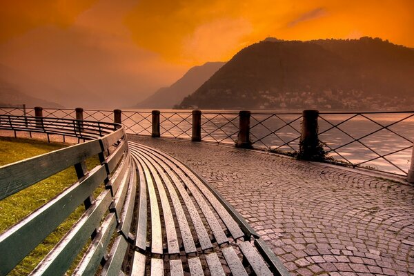 Beautiful sunset on the background of mountains and water