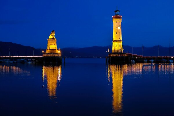 Lighthouse in the glow of sunset, twilight waters