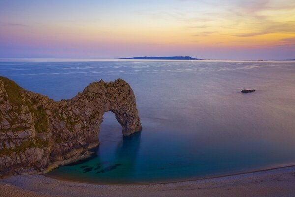 Panorama of the sea with a beach and a cliff overlooking the island