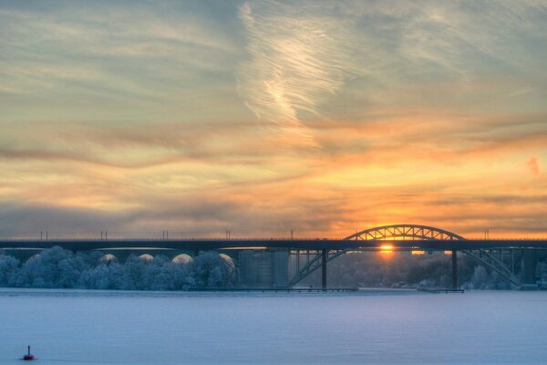 Railway post on the background of sunset. Winter landscape