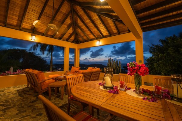 Cozy evening on the veranda with wooden furniture