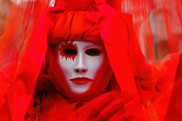 White mask with red lipstick in a red suit