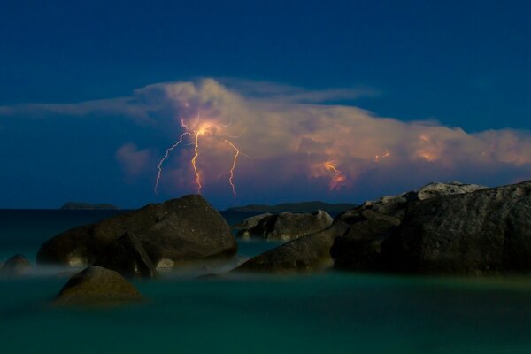 Lightning in the night sky over the sea