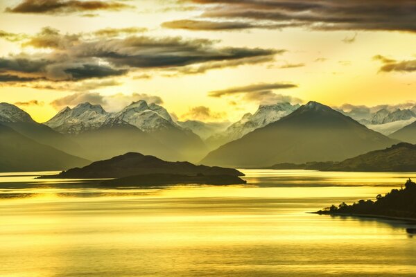 Beautiful sunrise near water and mountains