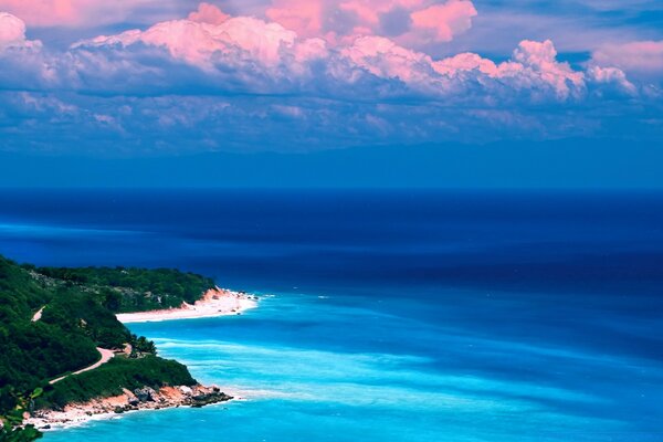 Pink clouds over the dark blue sea