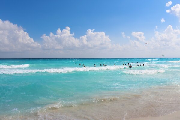 People bathe in azure-colored water