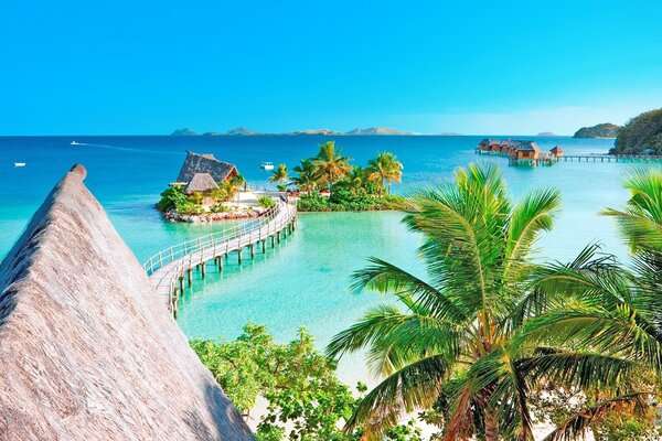 Wooden bridge to the house in the sea