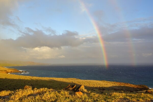 Two rainbows fall into the sea