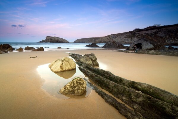 Sandy beach with big rocks