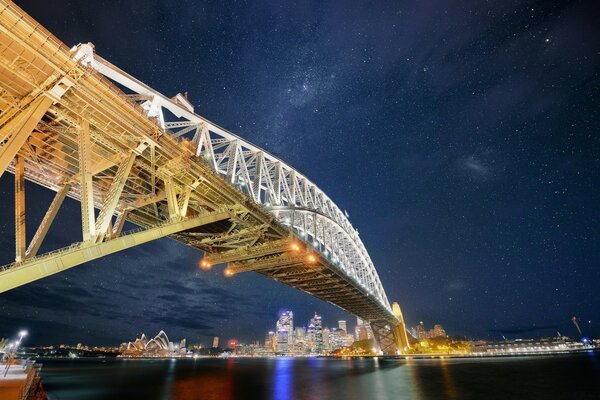 Illuminated bridge against the night sky