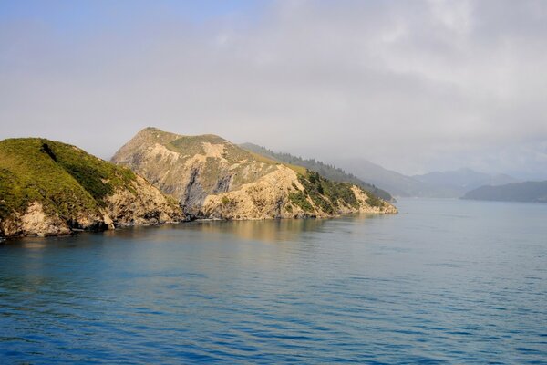 A beautiful rocky shore and a haze of fog in the distance