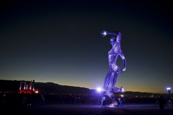 A huge glowing statue of a woman