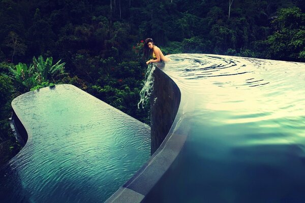 A man swims in a beautiful pool