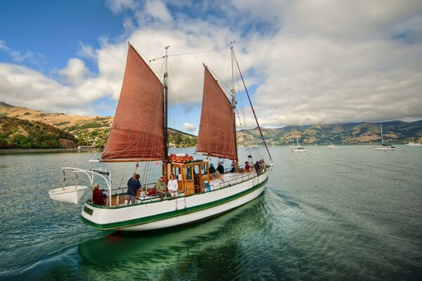 A boat with people floating on the water